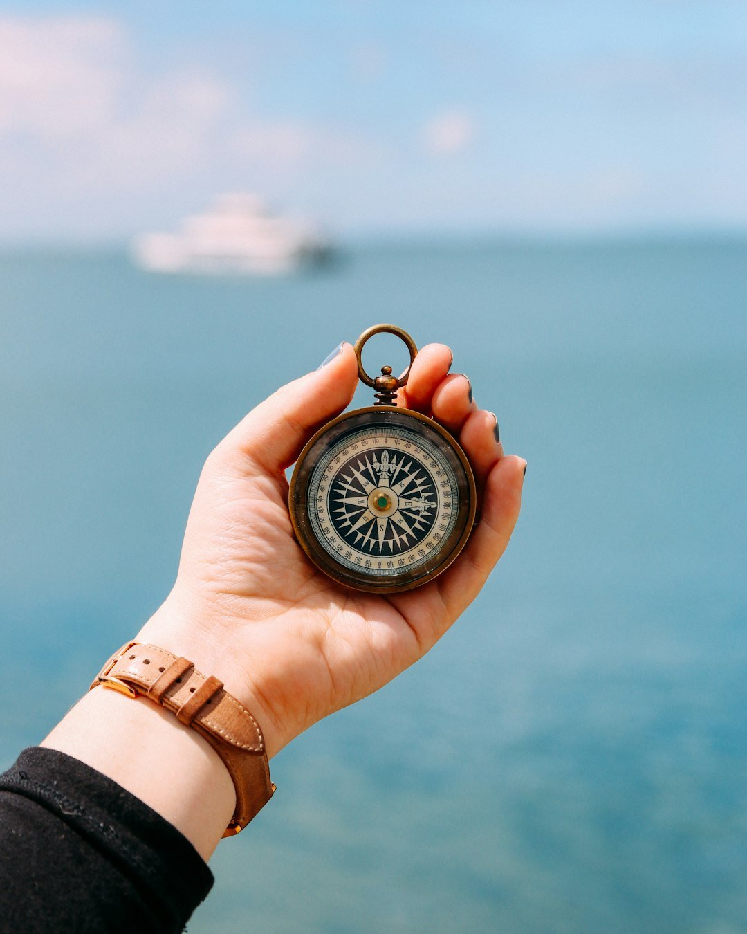 person-holding-compass-mhc0qj7l-ls